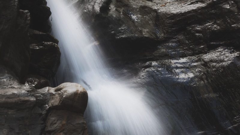 Flowing waterfall cascading down rocky cliffs in the Chiffa region of Algeria.
