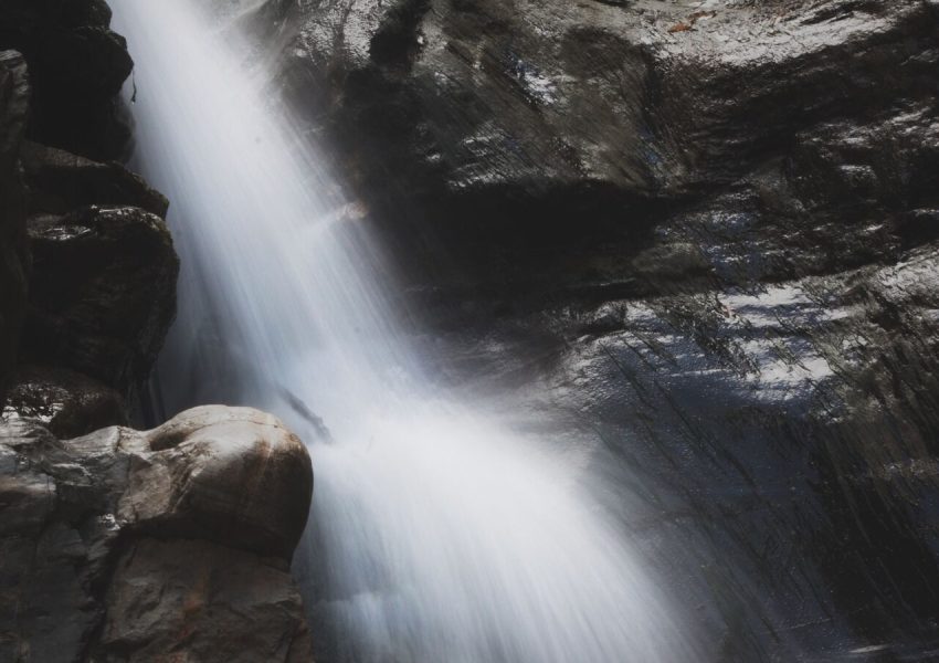 Flowing waterfall cascading down rocky cliffs in the Chiffa region of Algeria.