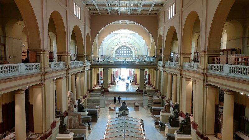 Wide view of the Egyptian Museum's main hall showcasing ancient sculptures and architecture.