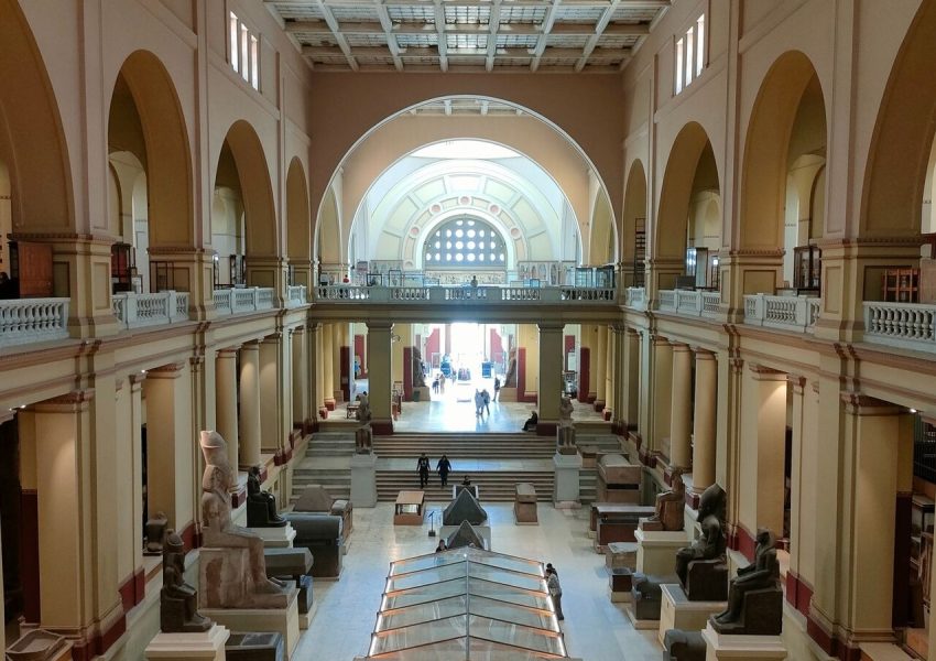 Wide view of the Egyptian Museum's main hall showcasing ancient sculptures and architecture.