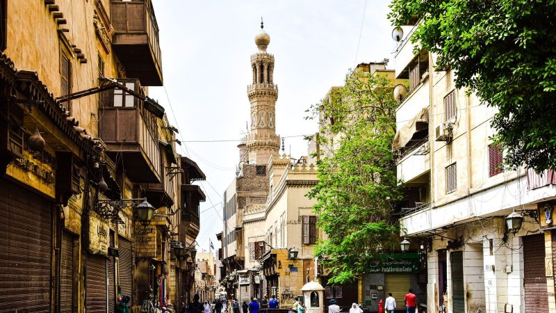 Explore the charm of a bustling historic street in Cairo with stunning architecture and cultural vibrancy.