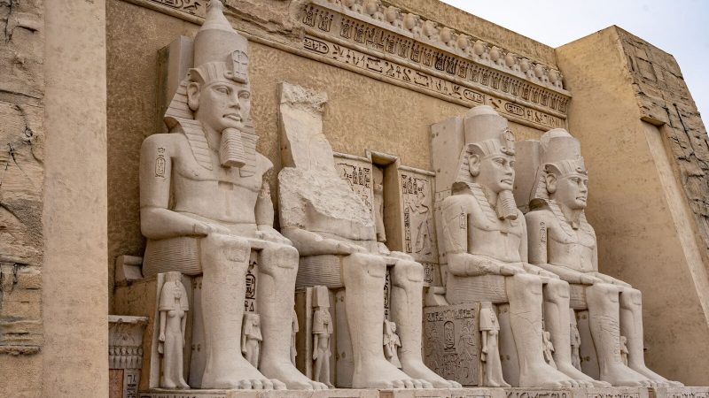 Close-up of Egyptian pharaoh statues in Chino, resembling ancient temple art.