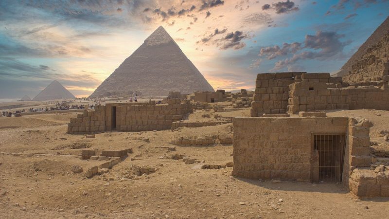 Captivating view of Giza Pyramids at sunrise in Cairo, showcasing ancient Egyptian architecture.