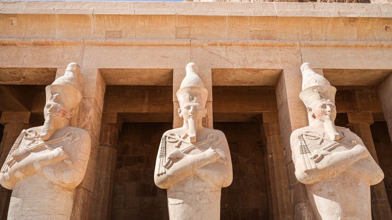 Three statues at Hatshepsut's temple demonstrate ancient Egyptian architecture.
