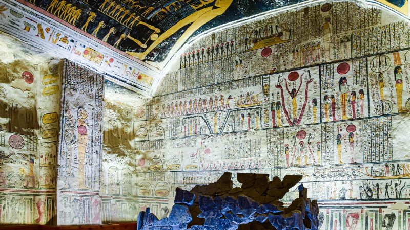 Vibrant frescoes and hieroglyphics inside an ancient Egyptian tomb showcasing historic art and culture.