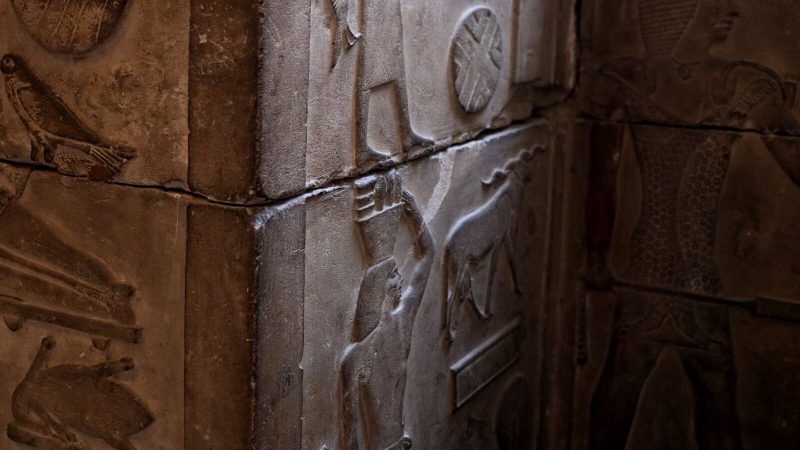 Close-up of detailed ancient Egyptian stone carvings in a Cairo museum showcasing cultural art and architecture.