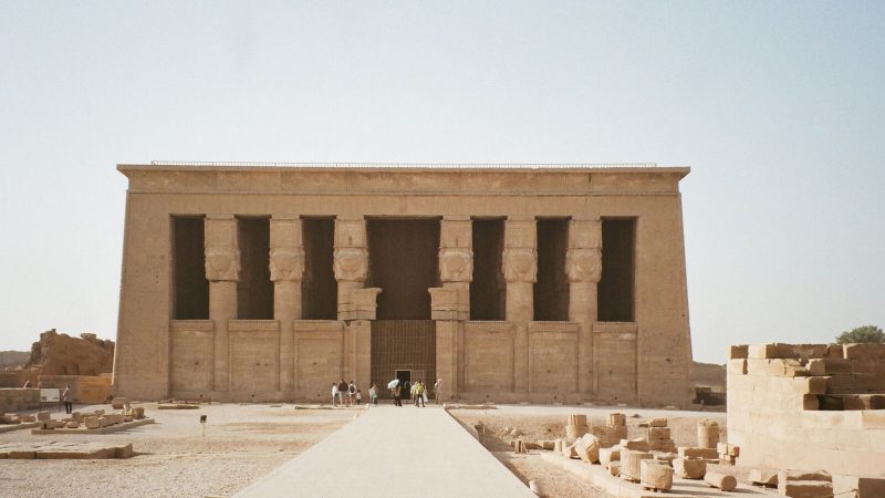 Front view of the Temple of Hathor in Dendera, Qena, Egypt with clear blue sky.