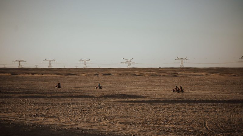 Experience the thrill of quad biking across the vast Egyptian desert landscape under a clear sky.