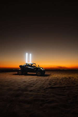Off-road vehicle in the Dubai desert at sunset