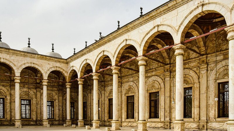 Exploring the iconic arches and columns of the Citadel's alabaster mosque in Cairo's Islamic architecture.