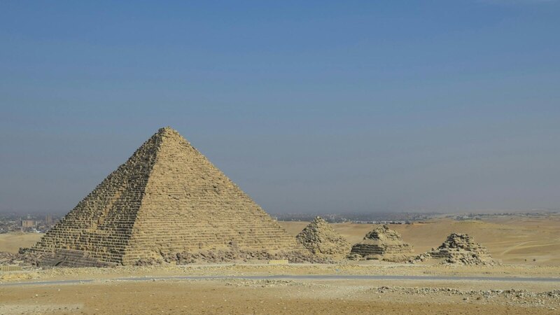 A stunning view of the Pyramids of Giza in Cairo, Egypt on a sunny day.