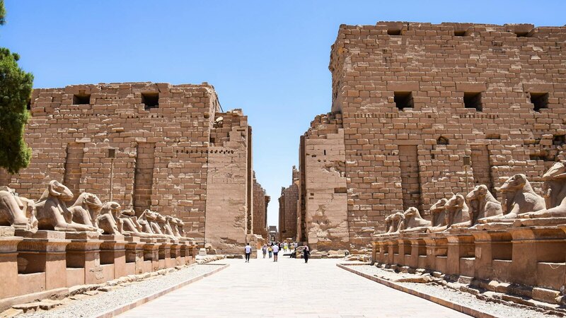 Karnak Temple's ancient ruins under a bright blue sky in Luxor, Egypt.
