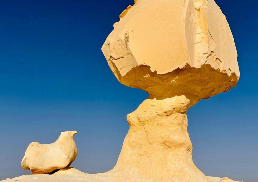 Sculptural rock formations under a clear blue sky in the White Desert, Egypt.