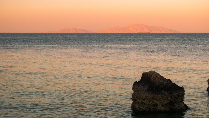 Serene beach scene at sunset in Sharm El-Sheikh, Egypt.