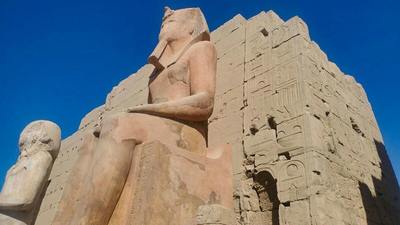 View of a large ancient statue at Luxor Temple, showcasing historic Egyptian architecture.
