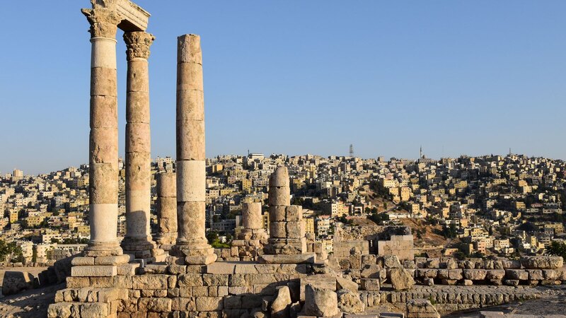 Majestic view of the Temple of Hercules ruins against Amman's sprawling cityscape.