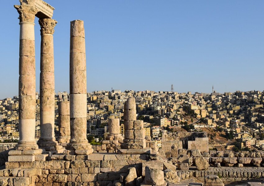 Majestic view of the Temple of Hercules ruins against Amman's sprawling cityscape.