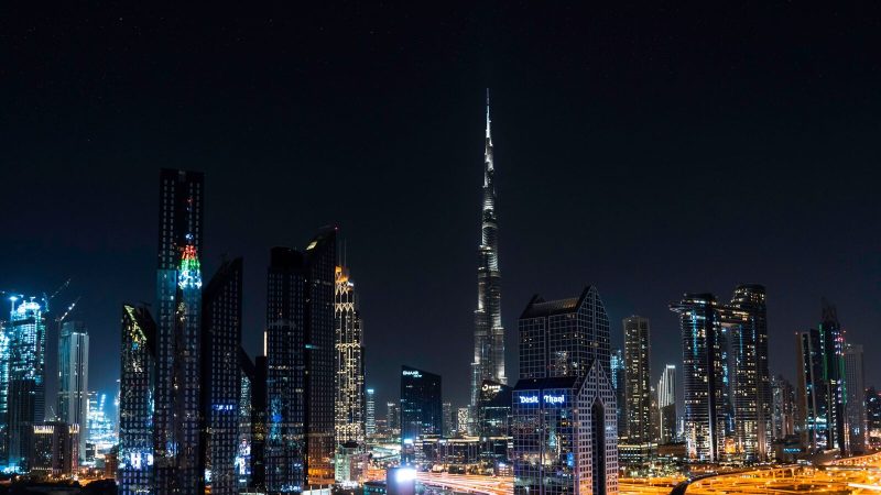 Stunning nighttime view of Dubai's skyline with the iconic Burj Khalifa illuminated under a starry sky.
