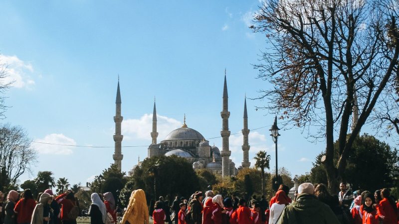 Visitors gather near the iconic Blue Mosque in Istanbul, a symbol of Turkish architecture.