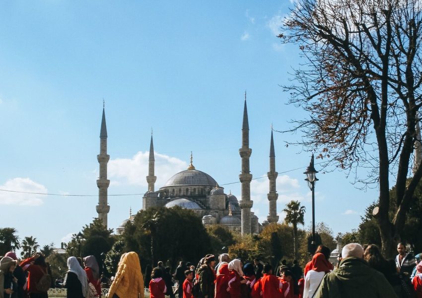 Visitors gather near the iconic Blue Mosque in Istanbul, a symbol of Turkish architecture.